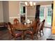 Spacious dining room with wooden table, chairs, chandelier, and view to the kitchen at 157 Blue Jacket Dr., Galivants Ferry, SC 29544