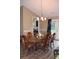 Spacious dining room with wooden table, chairs, chandelier, and view to the kitchen at 157 Blue Jacket Dr., Galivants Ferry, SC 29544