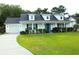 Charming single-story home featuring a well-manicured lawn, inviting front porch, and attached garage at 157 Blue Jacket Dr., Galivants Ferry, SC 29544