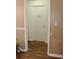 Hallway featuring wood floors, neutral-colored walls, and access to a bathroom at 157 Blue Jacket Dr., Galivants Ferry, SC 29544