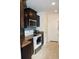 View of a kitchen with dark cabinets, tile backsplash and stainless steel microwave at 157 Blue Jacket Dr., Galivants Ferry, SC 29544