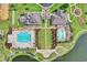 Aerial view of the community amenities including pools, playgrounds, clubhouse and a lake surrounded by lush landscaping at 3681 White Wing Circle, Myrtle Beach, SC 29579