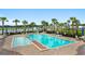 Enjoy the community pool with lounge chairs, umbrellas and views of the lake with a fountain in the background at 3681 White Wing Circle, Myrtle Beach, SC 29579