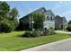 Well-maintained home featuring an expansive green lawn, mature landscaping, and serene neighborhood views at 3681 White Wing Circle, Myrtle Beach, SC 29579