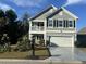 Charming two-story home with a cozy front porch and well-maintained landscaping and a two-car garage at 3681 White Wing Circle, Myrtle Beach, SC 29579