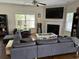 Inviting living room featuring a fireplace, hardwood floors, and large windows for natural light at 3681 White Wing Circle, Myrtle Beach, SC 29579