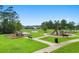 Enjoy outdoor fun at the community playground, featuring slides and climbing structures, set in a lush green space at 3681 White Wing Circle, Myrtle Beach, SC 29579