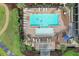 Aerial view of a community pool with multiple lounge chairs and lush landscaping at 3681 White Wing Circle, Myrtle Beach, SC 29579
