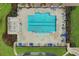 Aerial view of a community pool with marked lanes, blue umbrellas, and lounge chairs at 3681 White Wing Circle, Myrtle Beach, SC 29579