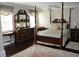 Elegant bedroom with a four-poster bed and dark wood furniture at 5632 Main St., Loris, SC 29569