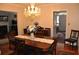 Formal dining room featuring a large table, chandelier, and hardwood floors at 5632 Main St., Loris, SC 29569