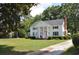 White house with black shutters and columns, long driveway at 5632 Main St., Loris, SC 29569