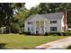 White house with black shutters and columns, spacious yard at 5632 Main St., Loris, SC 29569