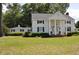 White house with black shutters, columns, and a large front yard at 5632 Main St., Loris, SC 29569