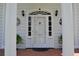 White front door with glass panels and columns at 5632 Main St., Loris, SC 29569