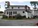 White two-story house with a brick walkway at 5632 Main St., Loris, SC 29569