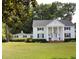 Two-story white house with columns and a front yard at 5632 Main St., Loris, SC 29569