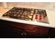 Stainless steel gas cooktop with red knobs in a modern kitchen at 5632 Main St., Loris, SC 29569