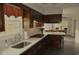 Kitchen with dark wood cabinets, gas stove, and white countertops at 5632 Main St., Loris, SC 29569