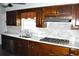 Kitchen with dark wood cabinets, gas stove and white countertops at 5632 Main St., Loris, SC 29569