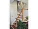 Wooden staircase with white railing and crystal chandelier at 5632 Main St., Loris, SC 29569