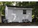 Small white shed with a bench in the backyard at 5632 Main St., Loris, SC 29569