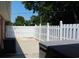 View of a white fenced backyard with trees, and a hot tub at 530 Swallow Ave. # 530, Myrtle Beach, SC 29577