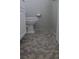 View of a bathroom floor and toilet, with grey tiling at 530 Swallow Ave. # 530, Myrtle Beach, SC 29577