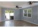 This living room has sliding glass doors that lead to the backyard, and is lit with a ceiling fan with lights at 530 Swallow Ave. # 530, Myrtle Beach, SC 29577