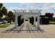 Charming white pergola-covered walkway flanked by lush greenery and shade trees at 530 Swallow Ave. # 530, Myrtle Beach, SC 29577