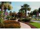 Landscaped street view featuring palm trees, seasonal flowers, and pedestrian walkways at 530 Swallow Ave. # 530, Myrtle Beach, SC 29577