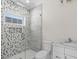 Bathroom with patterned shower and white vanity at 129 Serenity Point Dr., Little River, SC 29566