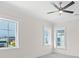 Bright bedroom with ceiling fan and multiple windows at 129 Serenity Point Dr., Little River, SC 29566