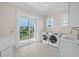 Laundry room with washer, dryer and exterior access at 129 Serenity Point Dr., Little River, SC 29566