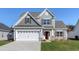 Two-story house with gray siding, white garage door, and landscaping at 308 Happy Valley Dr., Myrtle Beach, SC 29588