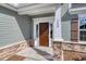 Brown front door with stone accents and white columns at 308 Happy Valley Dr., Myrtle Beach, SC 29588