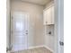 Laundry room with white cabinets and patterned floor tile at 308 Happy Valley Dr., Myrtle Beach, SC 29588