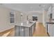 Modern kitchen with gray island, white cabinets, and stainless steel appliances at 622 Castle Ct., Myrtle Beach, SC 29579