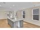 Modern kitchen with gray island, white cabinets, and stainless steel appliances at 622 Castle Ct., Myrtle Beach, SC 29579