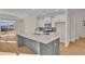 Modern kitchen with gray island, white cabinets, and stainless steel appliances at 622 Castle Ct., Myrtle Beach, SC 29579