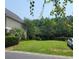 Spacious backyard with lush green grass and mature trees at Tbb 129 Charles Towne Ln., Murrells Inlet, SC 29576