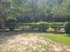 Empty lot with patchy grass and shrubs bordering a road at Tbb 129 Charles Towne Ln., Murrells Inlet, SC 29576