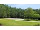 Outdoor basketball court surrounded by lush greenery at Tbb 129 Charles Towne Ln., Murrells Inlet, SC 29576