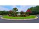 Landscaped entrance with circular driveway and fountain at Tbb 129 Charles Towne Ln., Murrells Inlet, SC 29576