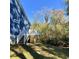 Wooden back deck with stairs leading to the backyard and surrounded by mature trees at 202 Rivers Edge Dr., Conway, SC 29526