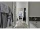 Bathroom features a gray-tiled floor, integrated bathtub, and a view leading into the bedroom at 202 Rivers Edge Dr., Conway, SC 29526