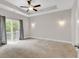 Bright bedroom featuring a ceiling fan, neutral walls, and a sliding glass door leading to a balcony at 202 Rivers Edge Dr., Conway, SC 29526