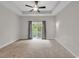 Spacious bedroom with a tray ceiling, ceiling fan and large window overlooking the outdoor scenery at 202 Rivers Edge Dr., Conway, SC 29526