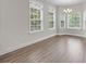 Light-filled dining room featuring luxury vinyl floors and large windows at 202 Rivers Edge Dr., Conway, SC 29526