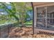 Screened porch overlooks fenced backyard, pond, and lush landscaping at 1202 Prince William Rd., North Myrtle Beach, SC 29582